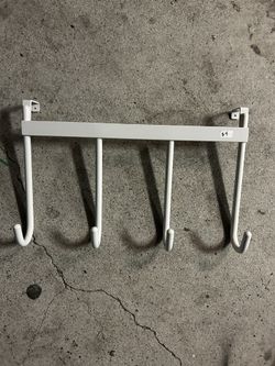 white metal over-the-door or under-shelf hanging rack with four hooks