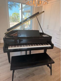 Beautiful Maeari baby grand piano in polished ebony