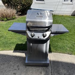 STAINLESS STILL,CHAR BROIL PROPANE BBQ GRILL. IT INCLUDES A PROPANE TANK WITH SOME GAS STILL IN IT. $100.00 OR BEST OFFER.