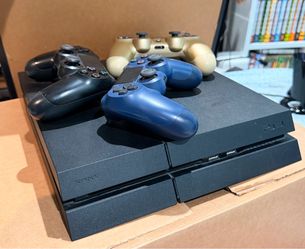 PlayStation 4 with 3 controllers and several games