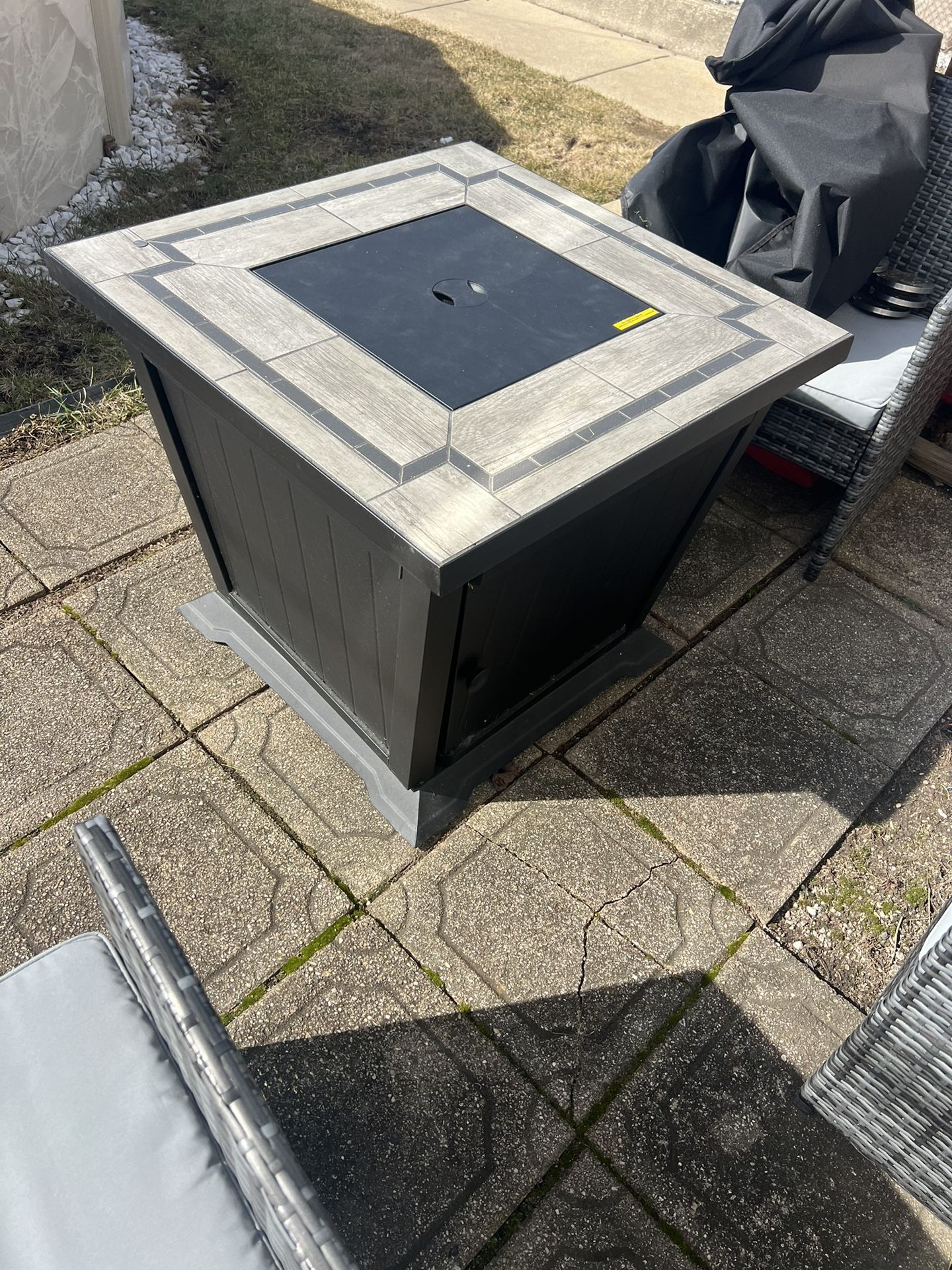 Gas fire pit with clear rocks and cover can be used as a table or fire pit heavy