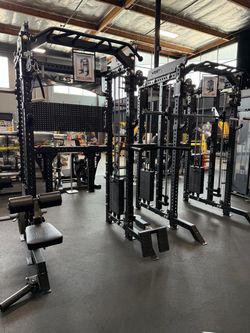 Smith machine squat rack home gym dumbbells kettlebells rubber flooring bench bar leg press weights bumper plates