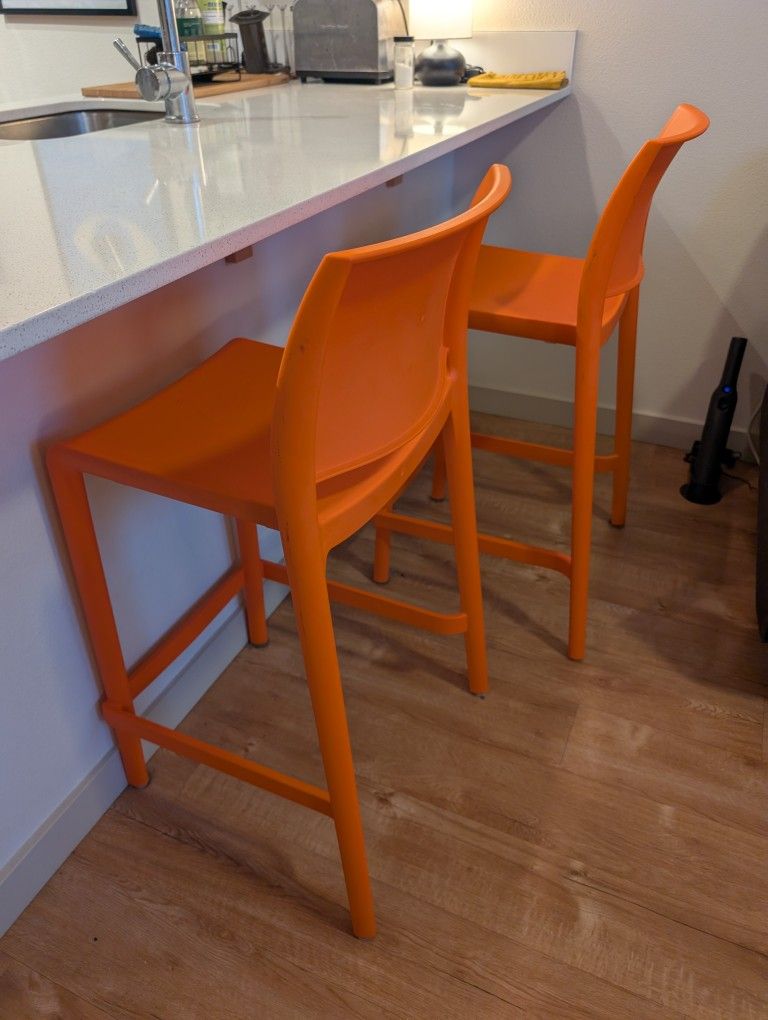 Two Orange Bar Stools