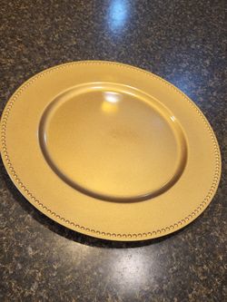 Charger 13-inch metallic gold beaded charger plate measured with a tape measure. single charger