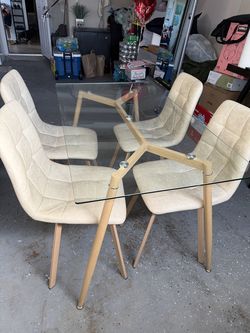 Glass top dining table with 4 upholstered chairs