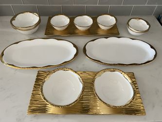 Gold rim ceramic serving bowls and platters