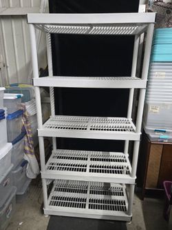 White 5-tier plastic shelving unit. Has vented shelves. Good for garage storage or basement. Sturdy and useful.6ft tall 36x18