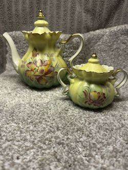 This vintage set is a Nippon hand-painted floral teapot and sugar set. 