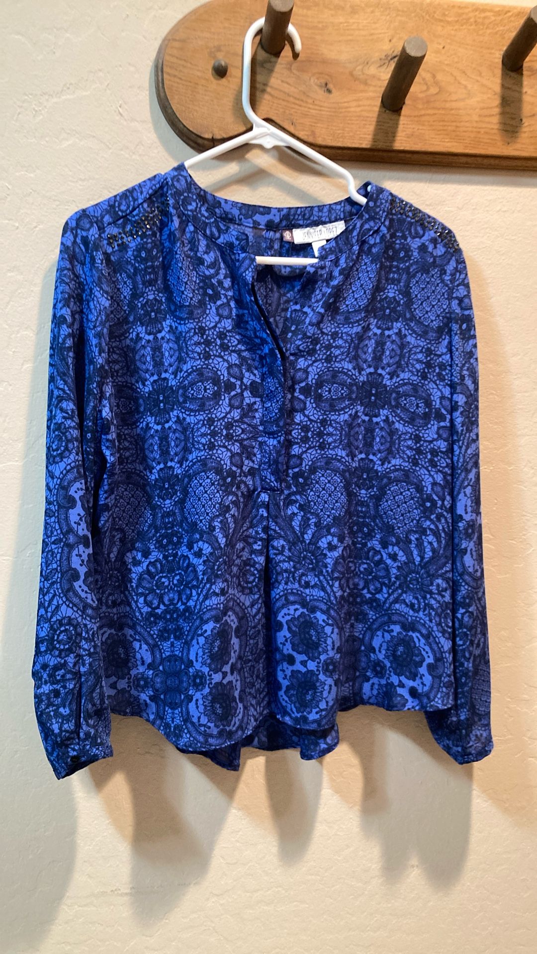 Woman’s Blouse by Jennifer Lopez, size Petite Large, blue print with black rhinestones on shoulders, worn once, excellent condition..100% polyester