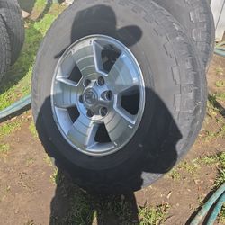 SET (4) RIMS AND TIRES. 