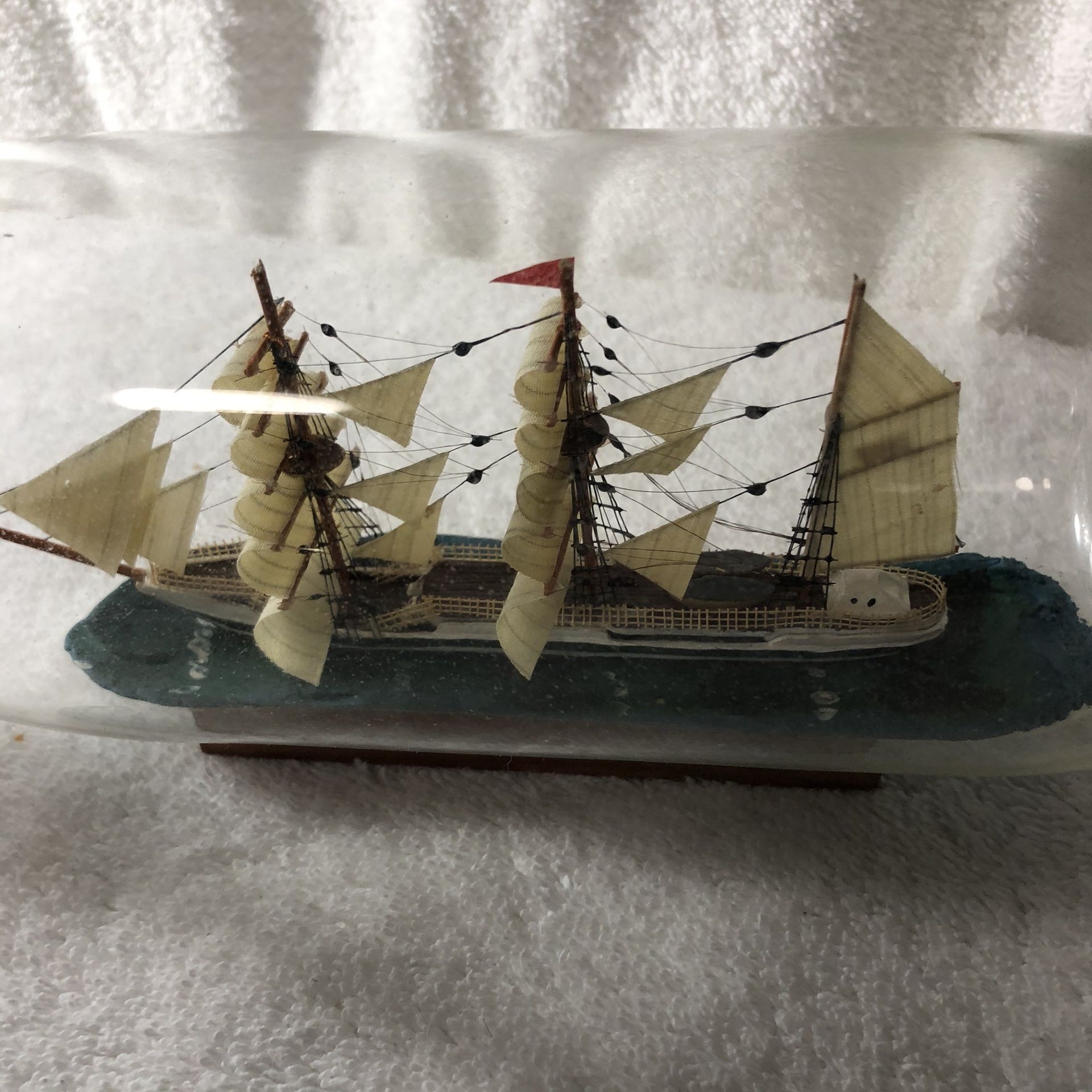 Ship in a bottle. 3.5 in tall x 10.5 in long x 3.5 in wide. Firm.