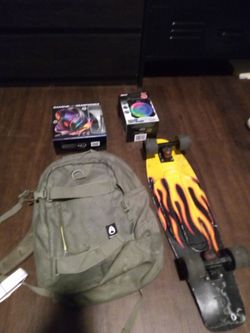 Skateboard with skateboard backpack speaker and headphones