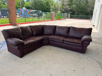 Beautiful burgundy, ( Leather/ Vinyl) L-shaped couches with reclining chair and pullout bed.