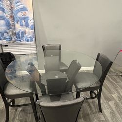 Glass rounded table with chairs