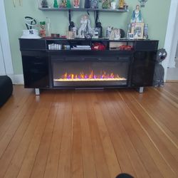 72in Electric Fireplace Good Condition 1 Burn Mark On Top From Candle Bluetooth Tooth Speakers 3 Years Old From Bob's Discount Furniture...
