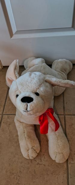 Melissa & Doug Sunny Yellow Lab plush dog with a red satin bow.