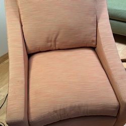 Pair Of upholstered accent armchairs with a textured Orange fabric and wood legs.