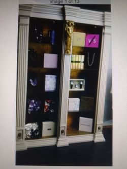Display With Glass Shelves And Gold Logos. China Cabinet. 