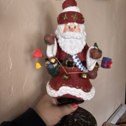 Christmas decor Santa Claus 12” on a spring and metal base he’s holding a string of 3 bells