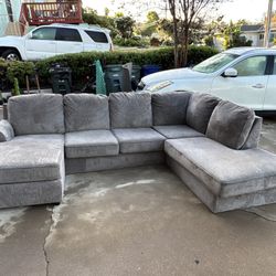 Gray Ashley Furniture U-Shaped couch.