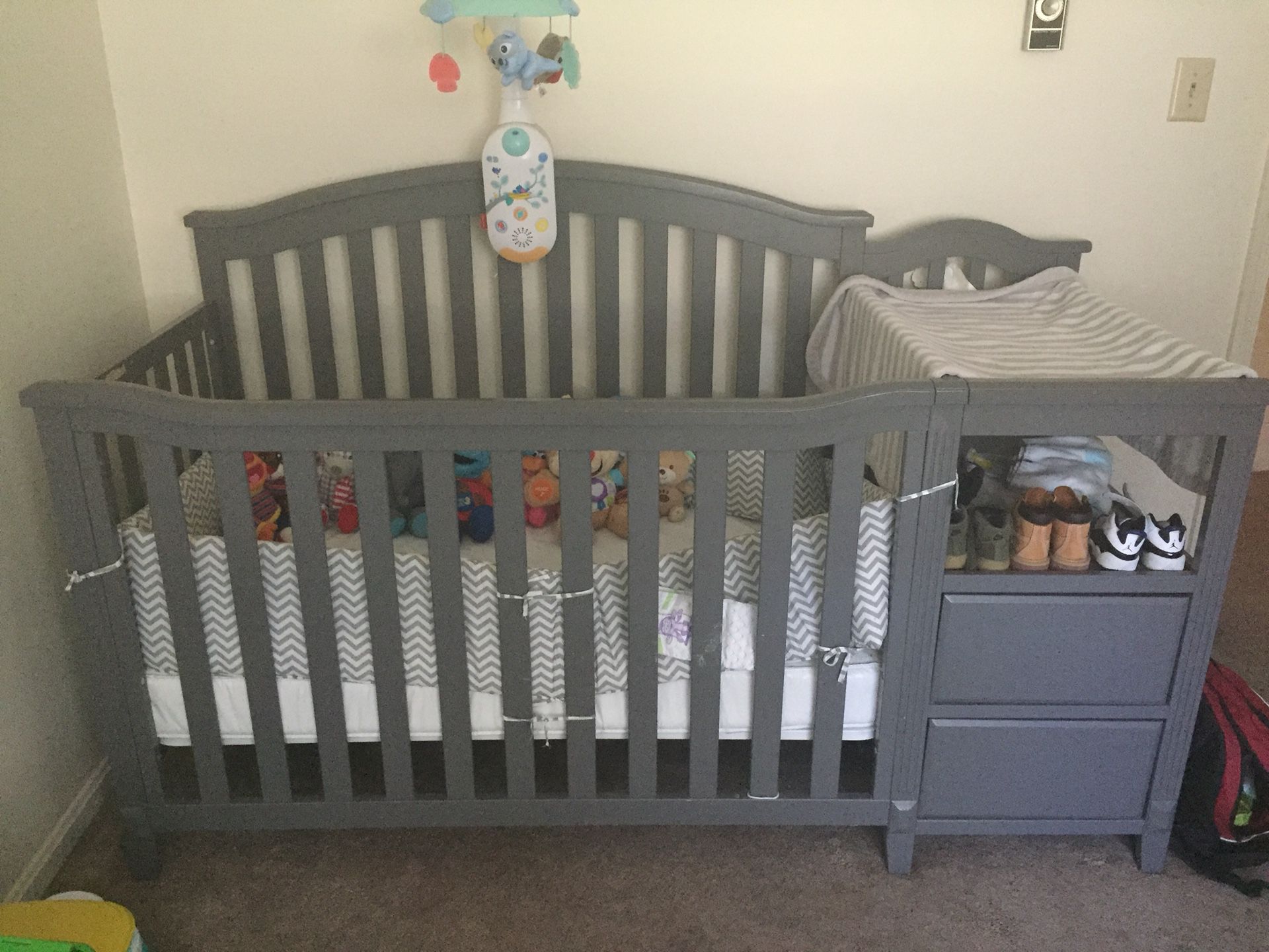 Convertible crib with changing table, mattress, bumper, and mobile