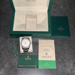 Rolex Datejust watch with a diamond-set bezel and a white dial