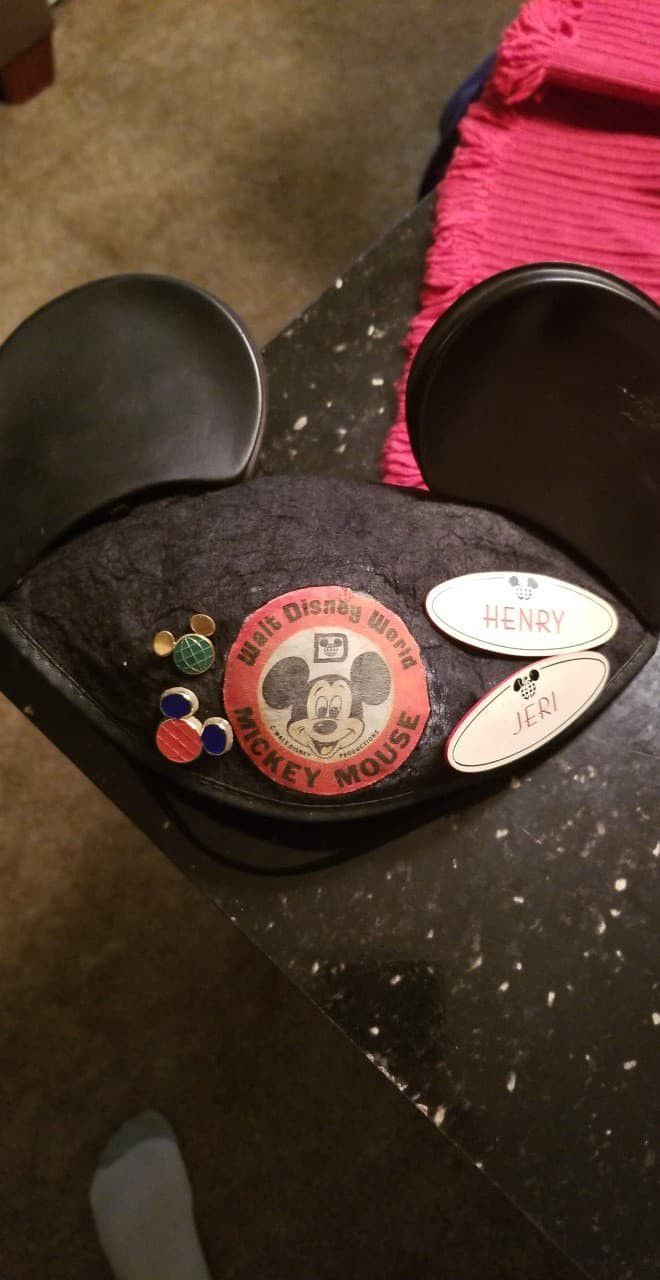 Disney Mickey ears with cast member exclusive anniversary pins and cast member name tags