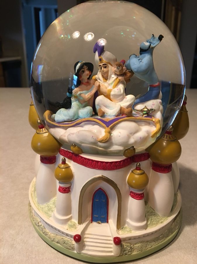 Disney Aladdin snowglobe. Plays “A Whole NewWorld” Approx. 6 1/2 in. Tall X 5 1/2 in. Wide
