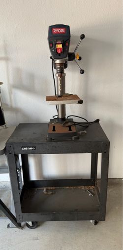 Ryobi 10-inch benchtop drill press resting on a Husky utility cart