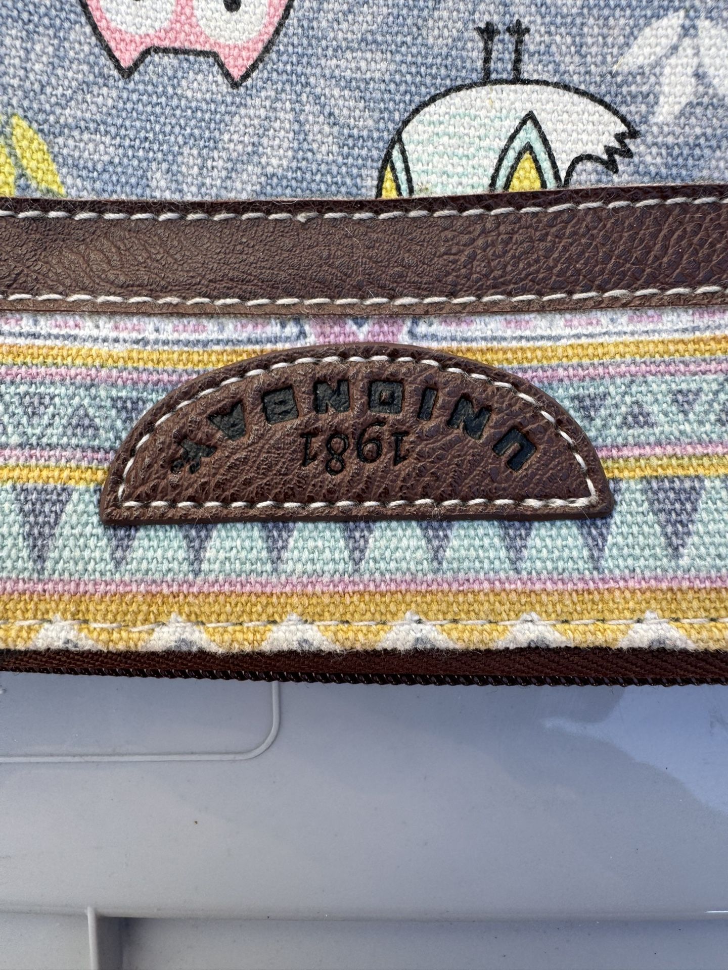 Unionbay canvas wristlet wallet featuring an owl and animal motif print
