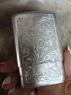 Vintage aluminum case embossed with floral pattern design.