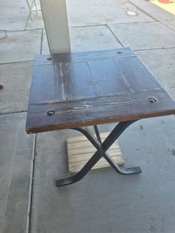 HomeRoots rustic brown and charcoal solid wood and iron cross legs end table.