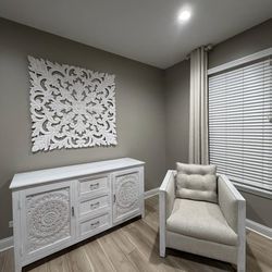 White carved sideboard, armchair, and coffee table