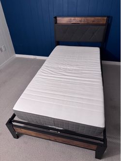 Twin bed frame with outlet on headboard