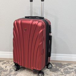 Olympia USA Vortex hardside spinner carry-on suitcase in the color red or wine. 