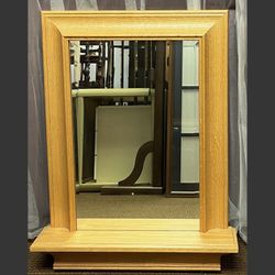 Wooden-framed wall mirror with shelf