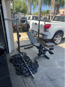 Bench press with 7ft 45lbs bar plus 250lbs of Olympic weights and curl bar