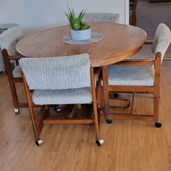 Wood Table And 4 Upholstered Roller Wheel Chairs