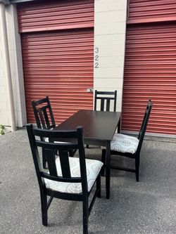 Black wooden table and four chairs