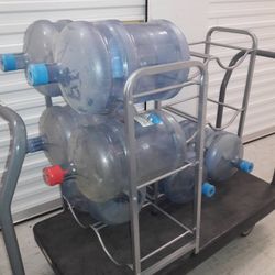 ** EMPTY 5 GALLON WATER JUG BOTTLES, CAPS, AND WATER JUG STANDS