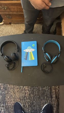 Two pairs of headphones and a journal