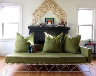 Geometric bed frame painted gold with thin mattress