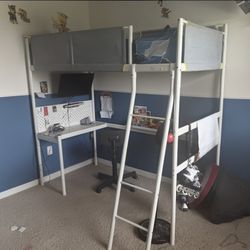 Raised twin bed with desk underneath 