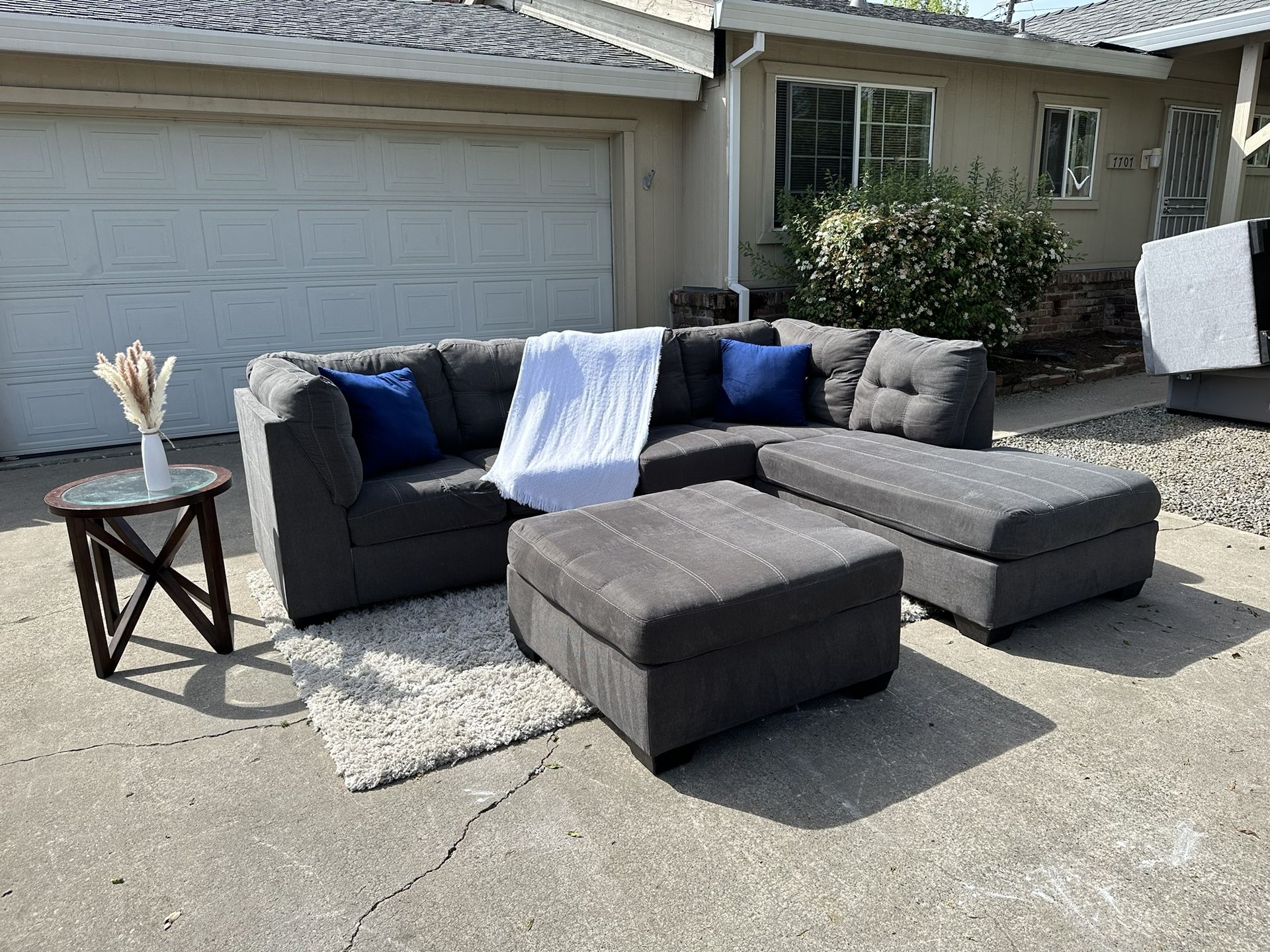 Free delivery Ashley Furniture gray 2-piece sectional couch with large ottoman retails $1250