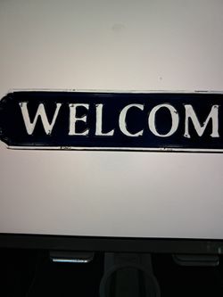  blue and white enamel welcome sign