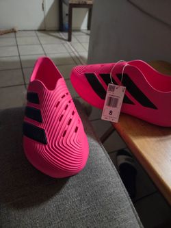 Size 8 male pink adidas Purechill slip-on shoes featuring contrasting black 3-Stripes.