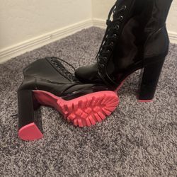 Black boots with pink underneath 