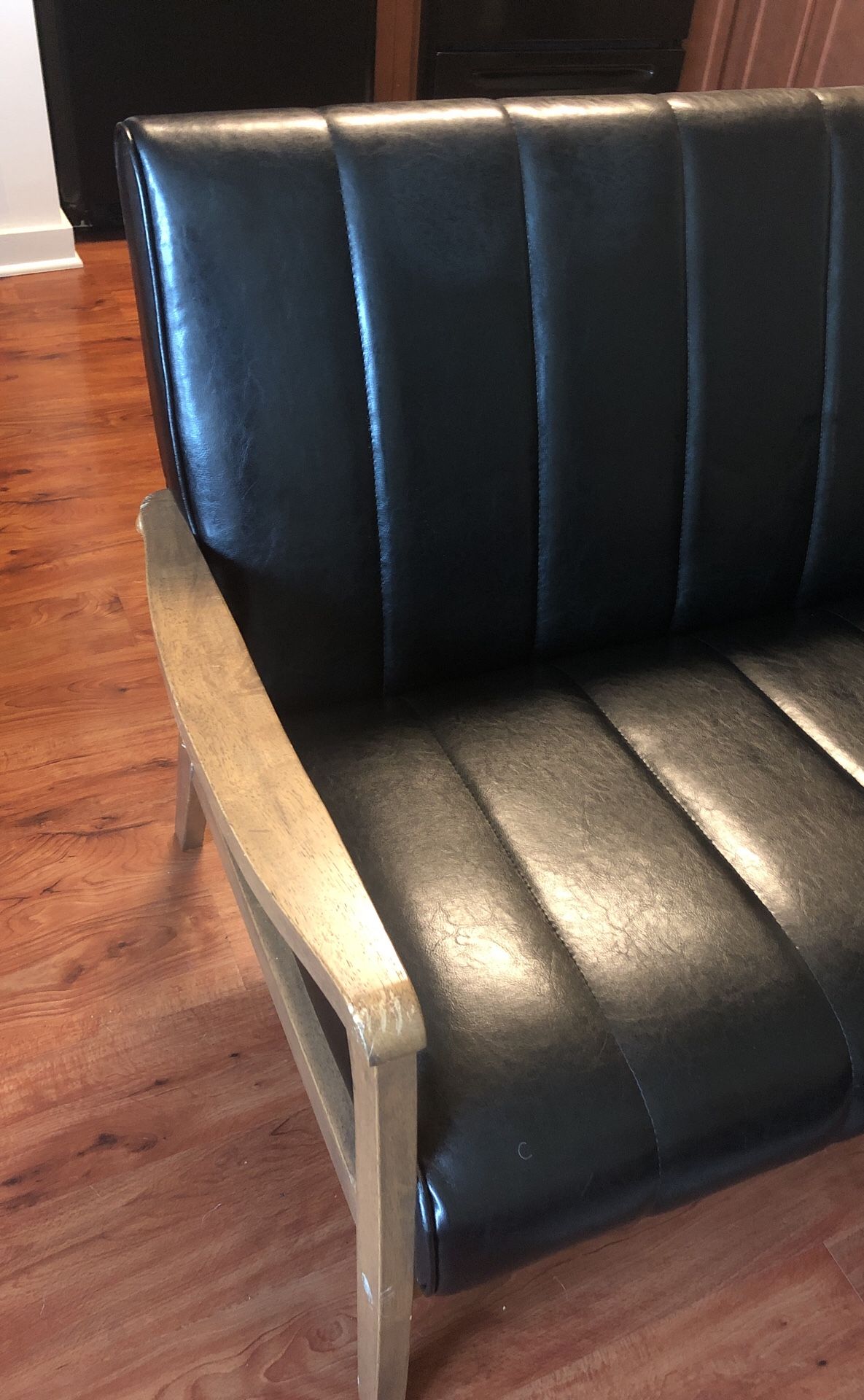 Leather couch with wooden arms