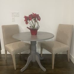 High end gray wood accent table with chairs from Crate and Barrel!