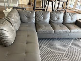 Faux leather gray sectional with ottoman